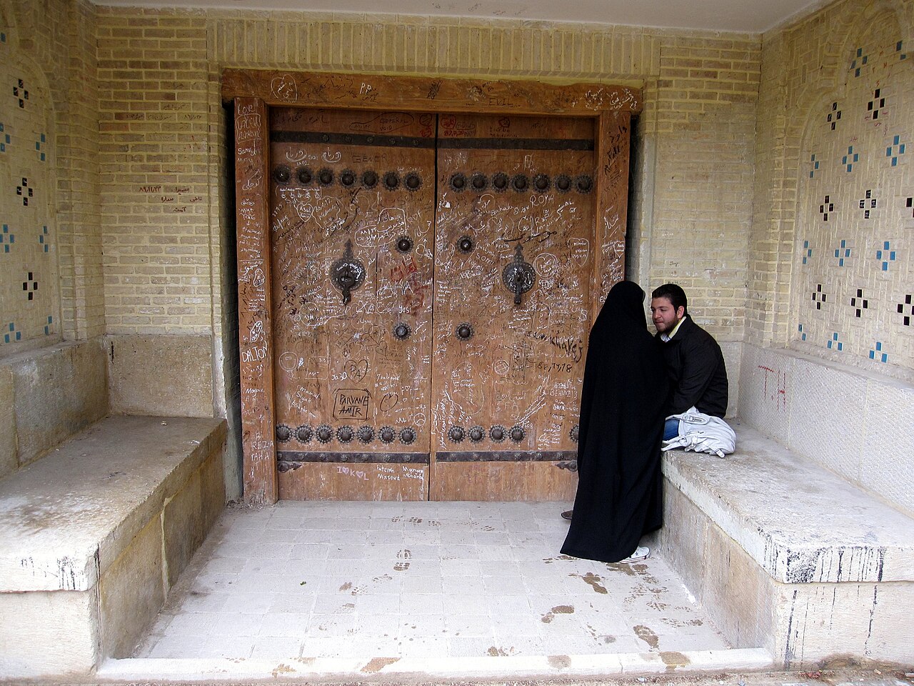 Couple having a serious conversation outside a doorway