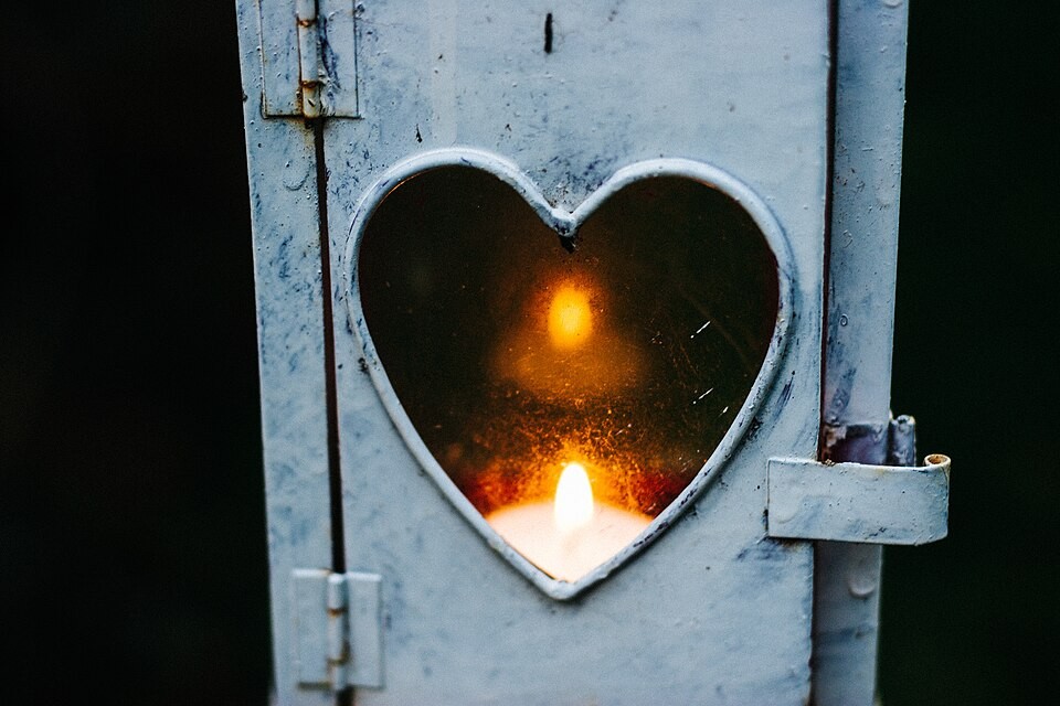 They Minimize Your Good News: What Is Missing From the Connection? Candlelight glowing through a heart-shaped opening in a lantern