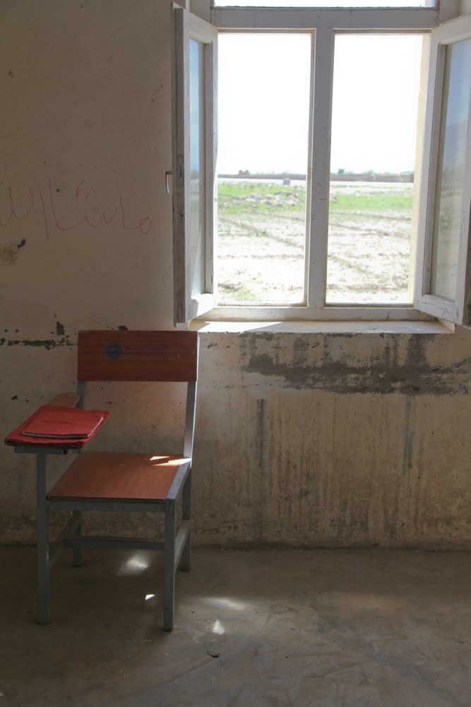 A chair is placed by the window in an empty classroom at a school near Bagram Airfield, Parwan province, Afghanistan, April 16, 2014 140416 A IY570 142